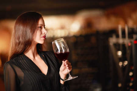 Beautiful girl with a wine glassの写真素材