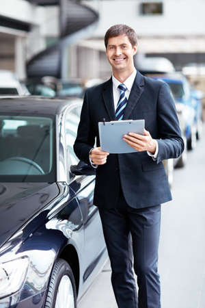 Man in suit at the carの写真素材
