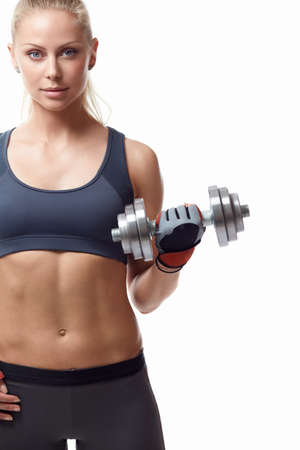 Sports girl with dumbbells on a white backgroundの写真素材