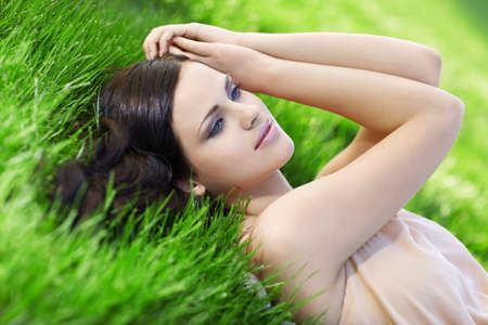 Young beautiful girl on grassの写真素材