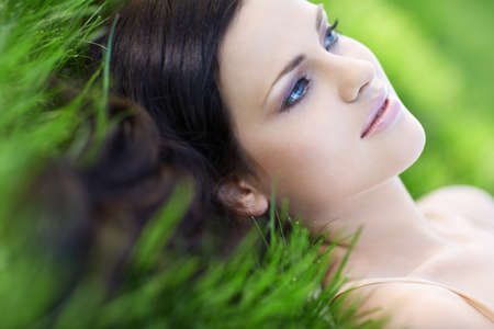 Girl with beautiful hair on grassの写真素材