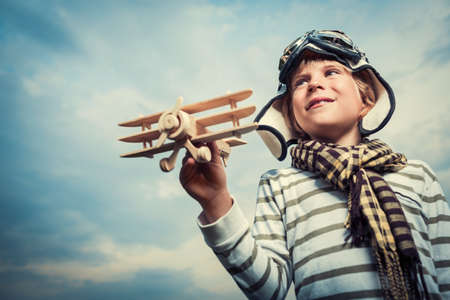 Little boy with wooden planeの写真素材