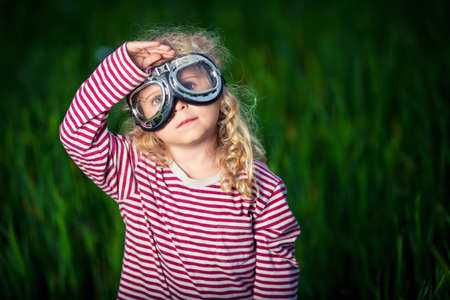 Little girl with glasses on grassの写真素材