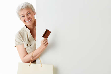 Elderly woman with bags and credit card