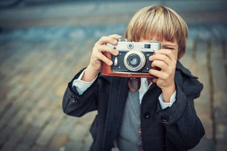Little boy with an old cameraの写真素材