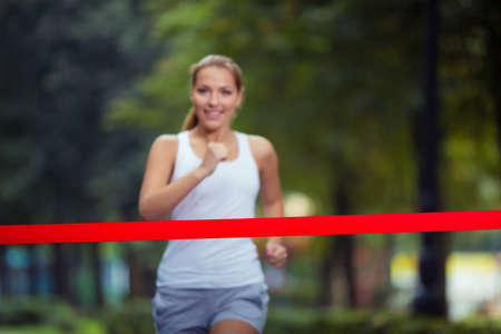 Young girl crosses finish lineの写真素材