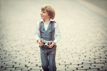 Little boy with retro camera outdoorsの写真素材