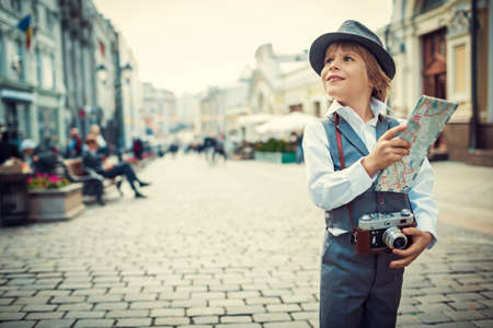 Little boy with a map on the streetの写真素材
