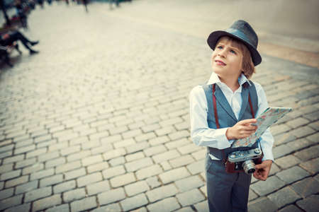 Little boy with a map on the streetの写真素材