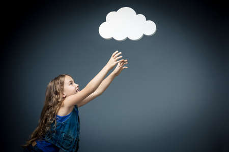 Little girl stretches to bubblesの写真素材