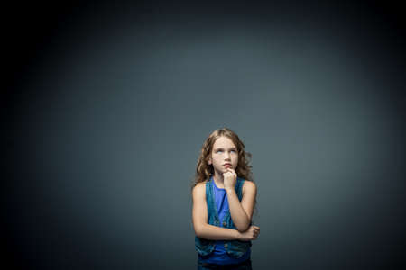 Thoughtful little girl in studio