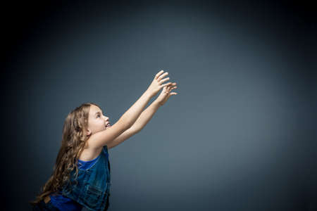 Little girl pulls hands upの写真素材