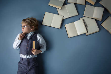 Little boy with books in studioの写真素材
