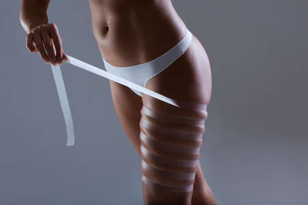 Woman with tape on hipの写真素材