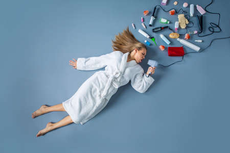 Attractive girl with a hairdryerの写真素材