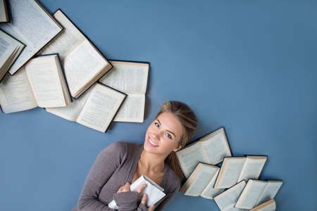 Young girl with books in studioの写真素材