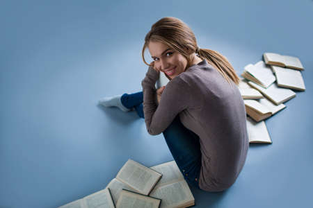 Attractive young female student in studioの写真素材