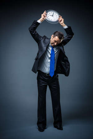 Man in suit with a clockの写真素材