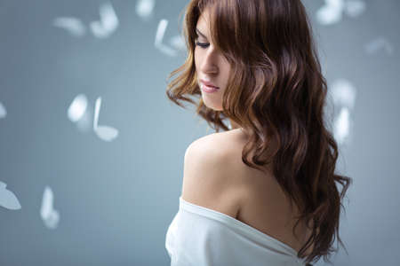 Young attractive girl with butterflies in studio