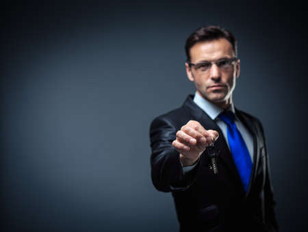 Business man with car keysの写真素材