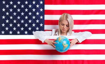 Young girl with American flag and globeの写真素材