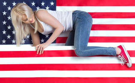 Young beautiful girl with American flagの写真素材