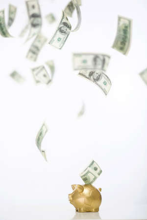 Flying money from piggy bankの写真素材