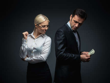 Businessman and businesswoman with moneyの写真素材