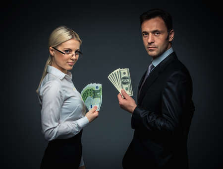 Businessman and businesswoman with moneyの写真素材