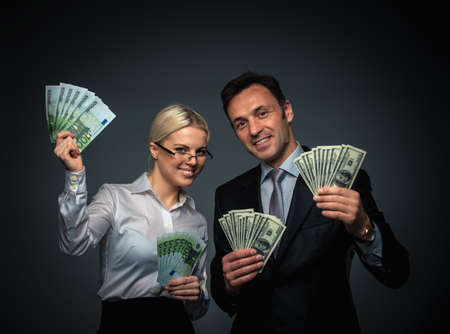 Businessman and businesswoman with moneyの写真素材