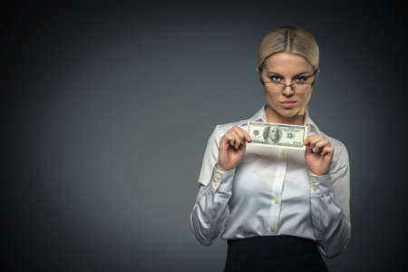 Businesswoman with money in studioの写真素材