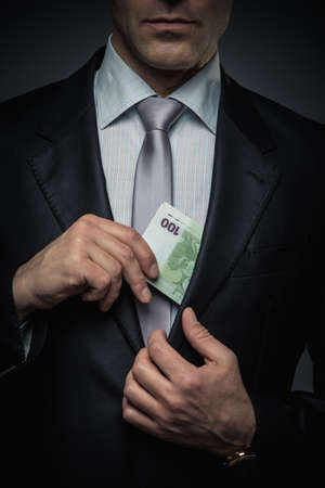 Businessman with money in studioの写真素材