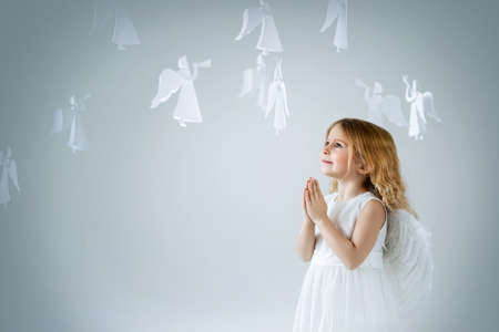 Little girl with wings in the studioの写真素材