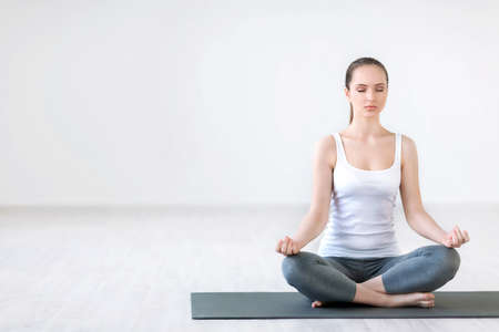 Young woman doing yoga in a studioの写真素材
