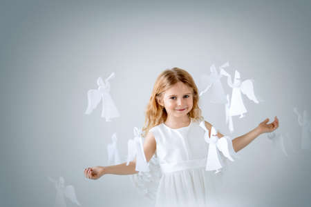 Little girl with the angelsの写真素材