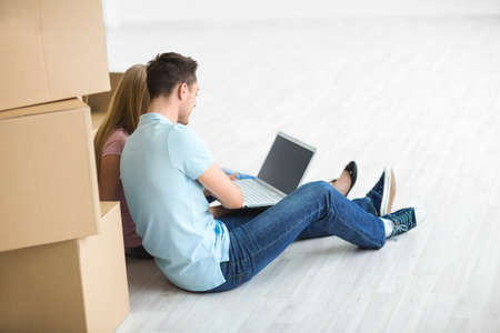 Young attractive couple with laptopの写真素材