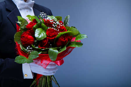 Man in a tuxedo with a bouquetの写真素材