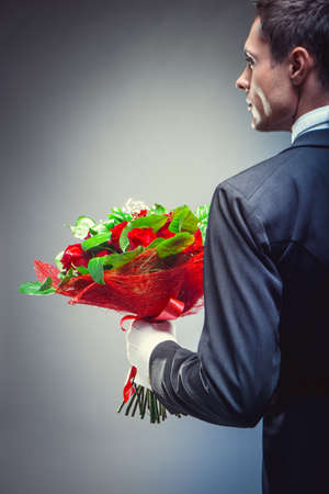 Man with bouquet of flowersの写真素材
