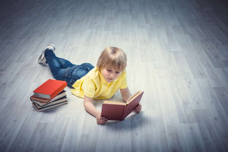 Little boy reading a bookの写真素材