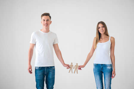 Young couple with cardboard objectsの写真素材