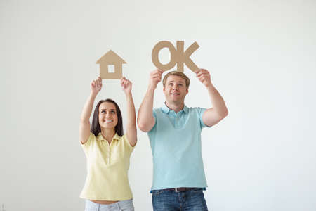 Young couple with cardboard objectsの写真素材