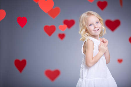 Little girl with hearts indoorsの写真素材