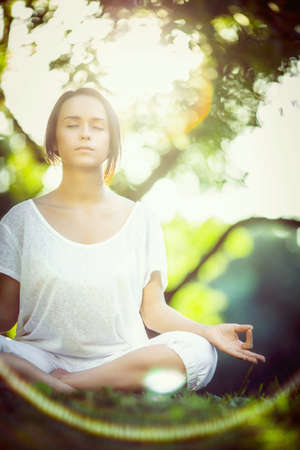 Young girl doing yoga in the parkの写真素材