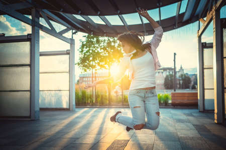 Young girl jumping outdoorsの写真素材