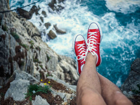 Men's feet on the cliffの写真素材