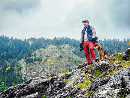 Young man with dog outdoorsの写真素材