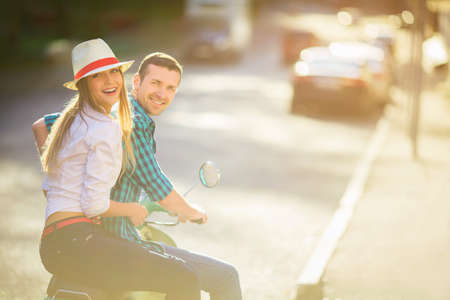 Happy people on a scooterの写真素材