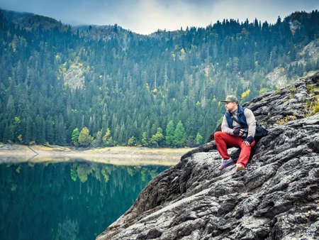 Man with the camera at the lake