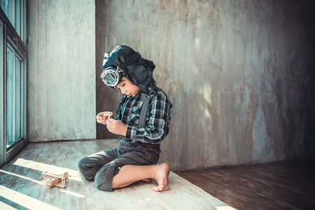 Little boy with plane indoorsの写真素材