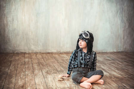 Little boy with airplane in the studioの写真素材
